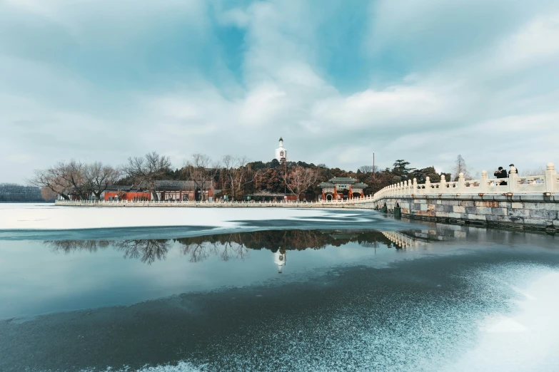a frozen body of water with buildings in the background