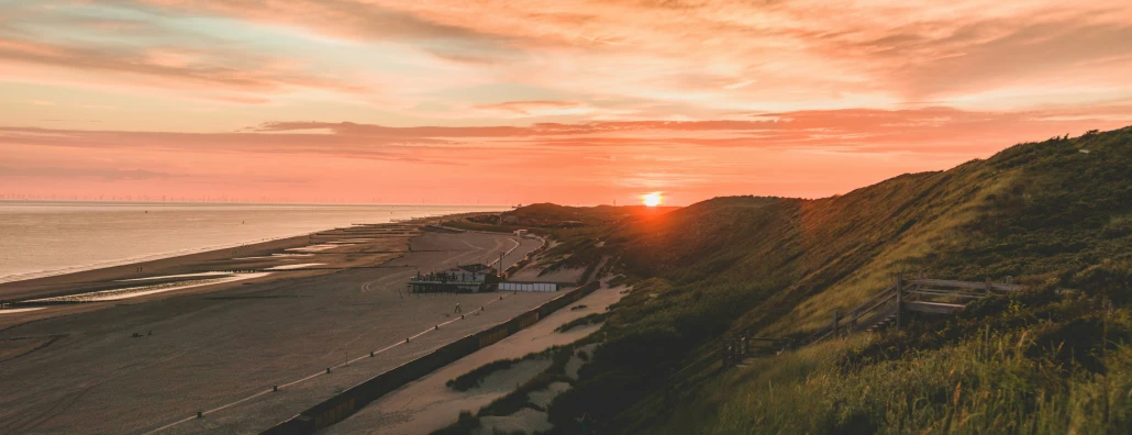 a view of a beach with a sunset