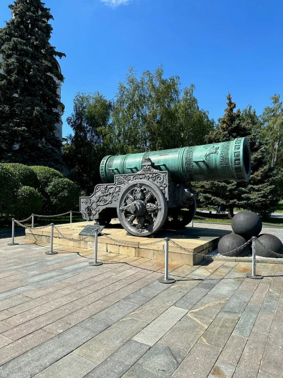 a green cannon sitting on top of a wooden deck