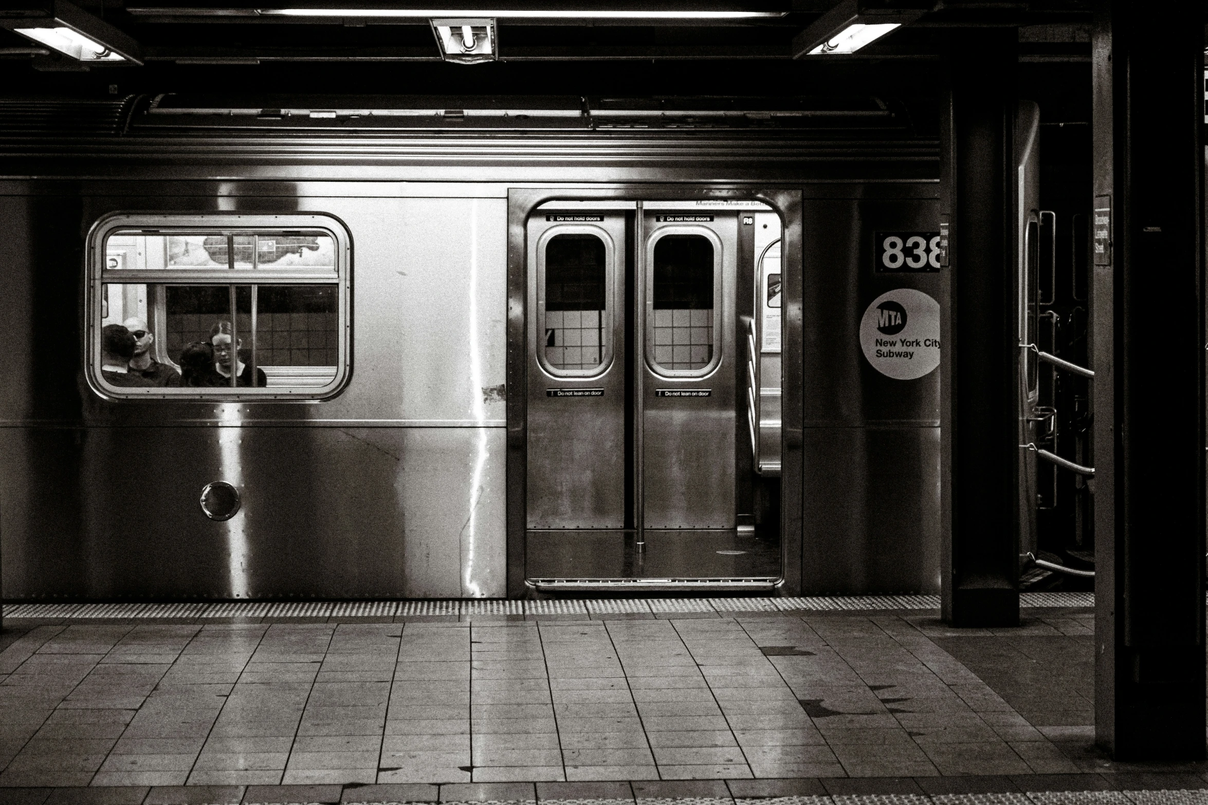 the doors of a train are opened in black and white