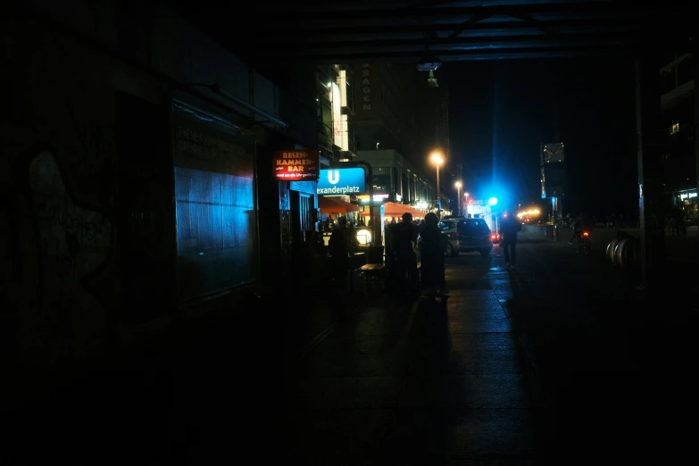 a dark street is dimly lit by the night