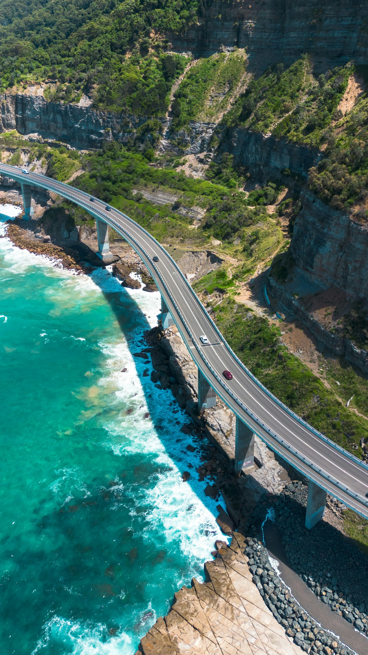 there is an aerial po of a bridge and ocean