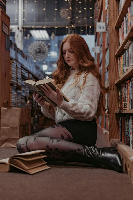 a woman in a liry holding an open book