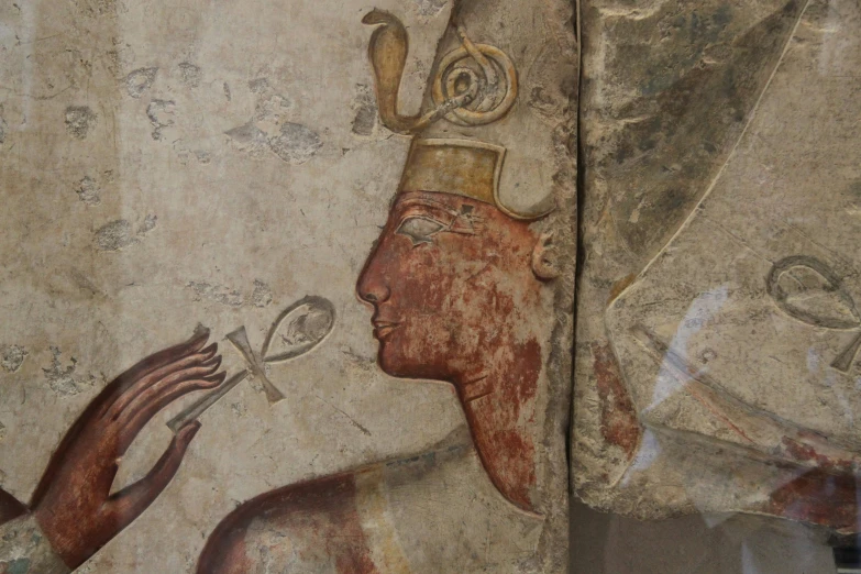 the ancient painted art shows two men holding up a spoon