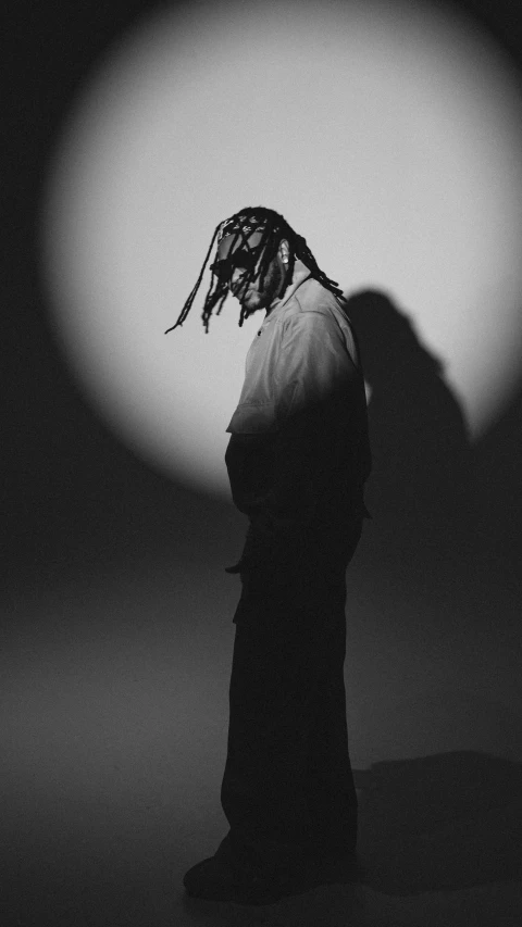 the silhouette of a man with dreadlocks on