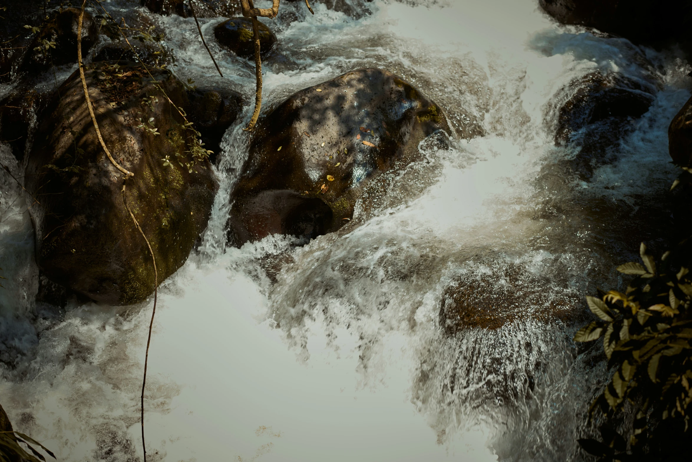 the water is rushing over the rocks that have fallen