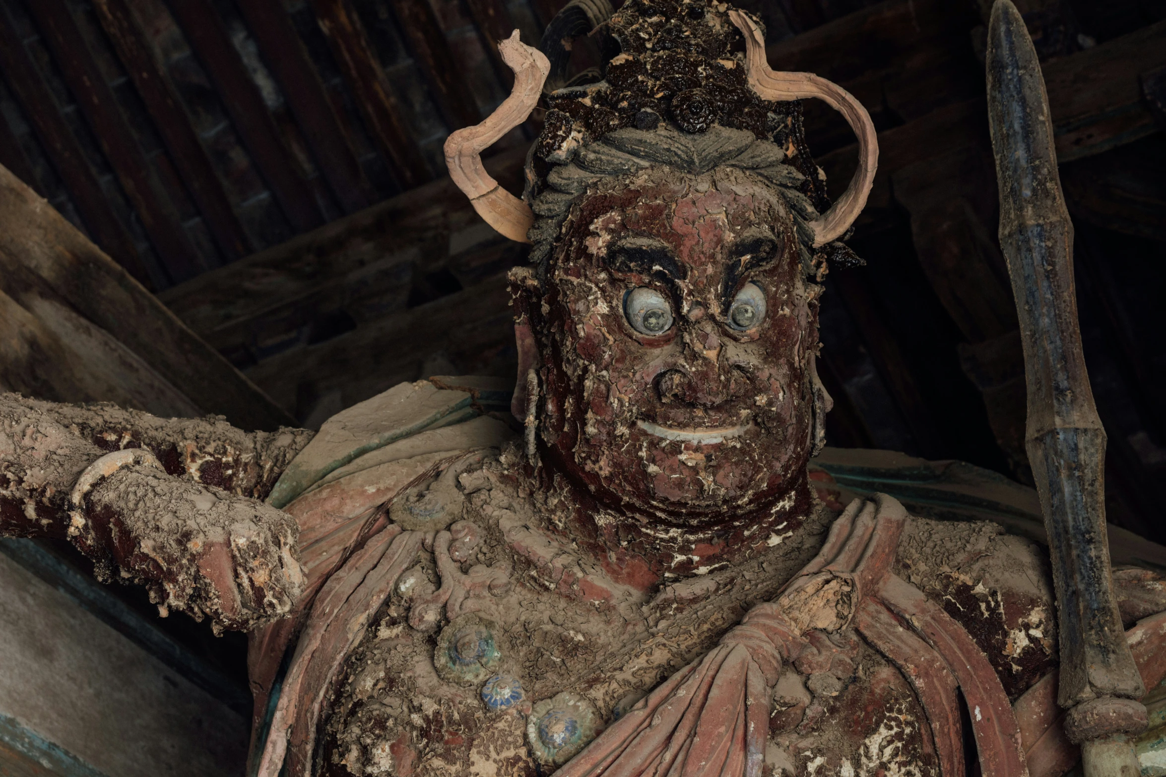 a statue of an asian demon with two horns