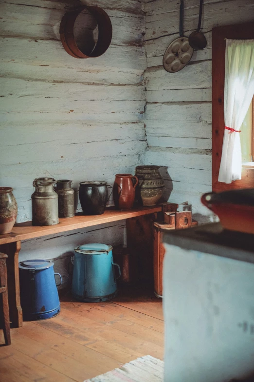 a room filled with pots, baskets, and table