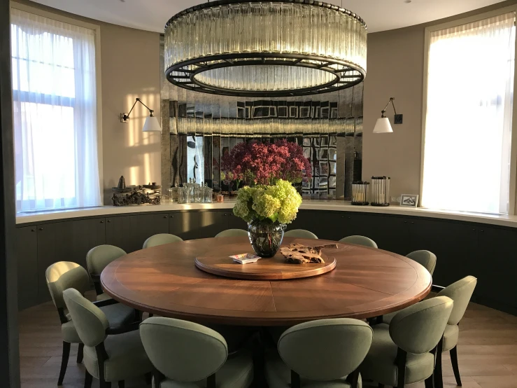 the table is in front of a large chandelier