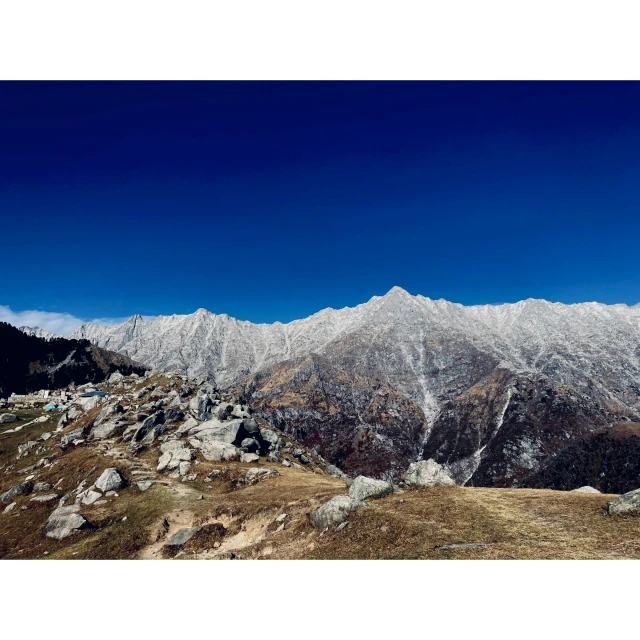 the view of snow covered mountains from a hill