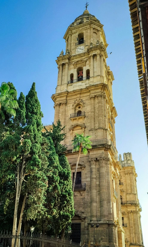 a large tower with a clock on top near trees