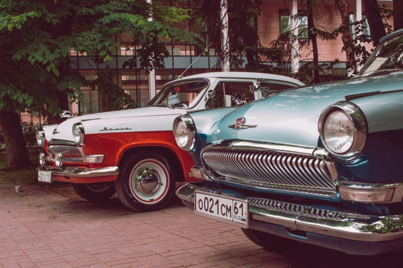 two old cars sitting next to each other