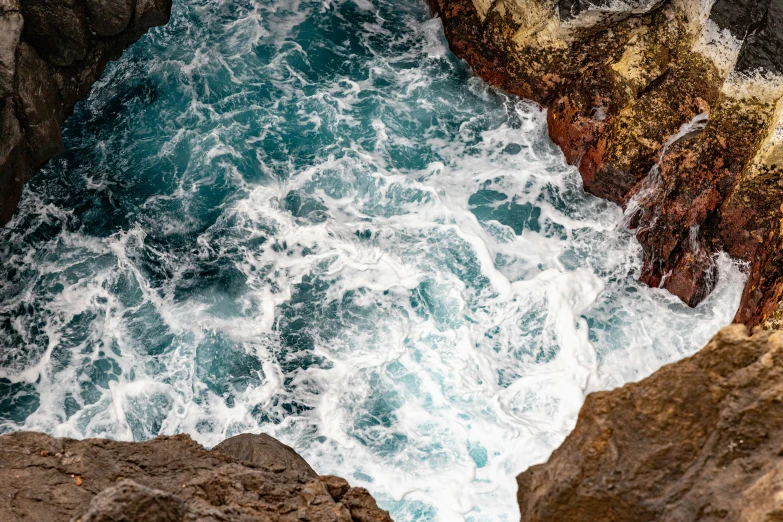 a bunch of rocks and water with waves coming out