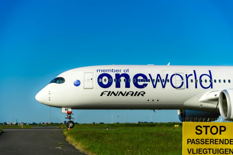 an airplane sits on the runway during the day