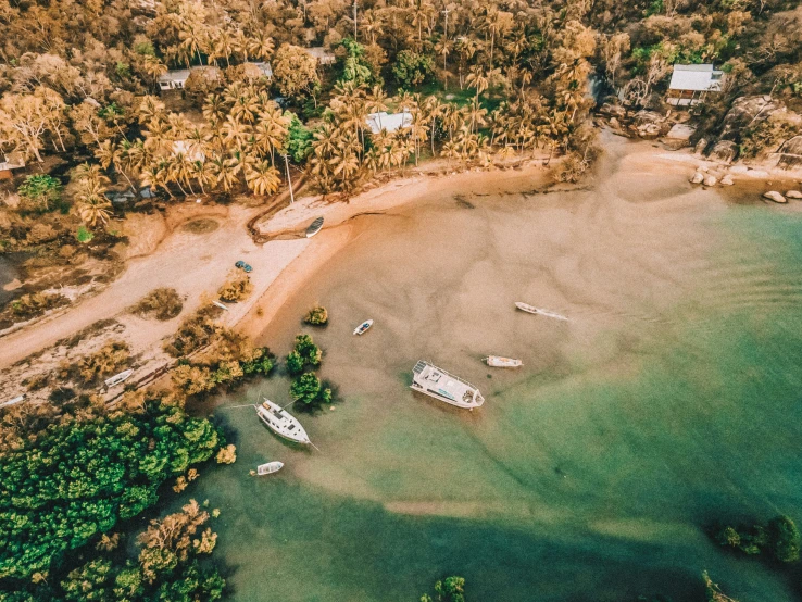 a beach with a small group of boats and two other boats