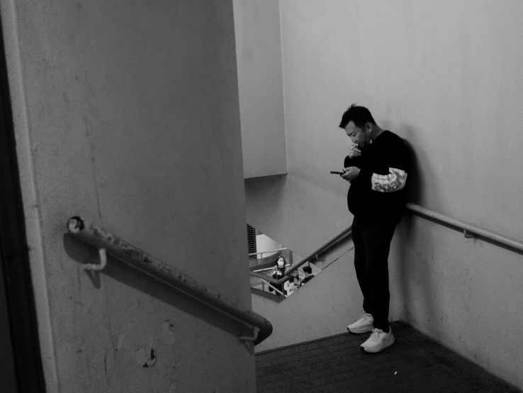 a black and white po of a man standing on some stairs