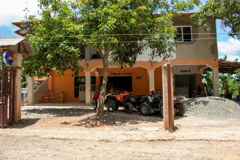 a tractor parked in front of a house on dirt