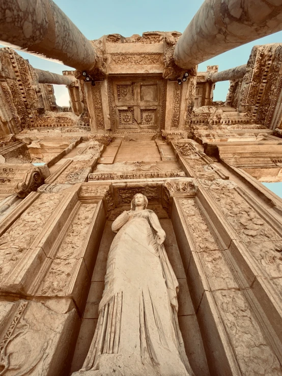 a statue sitting in the middle of an ancient building