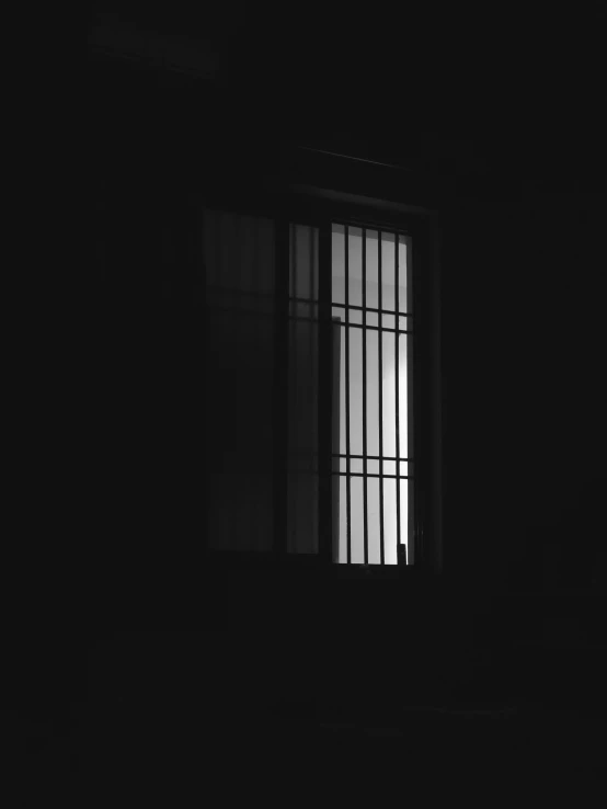 a window with bars drawn on it in the dark