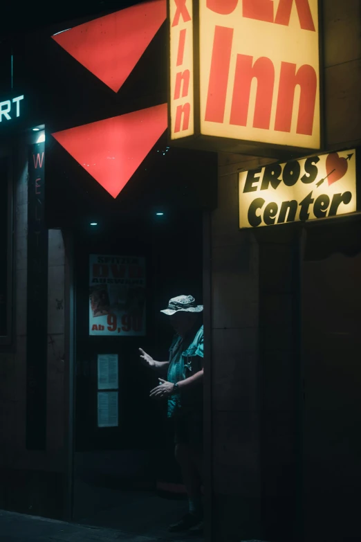 a woman walking past an art museum at night