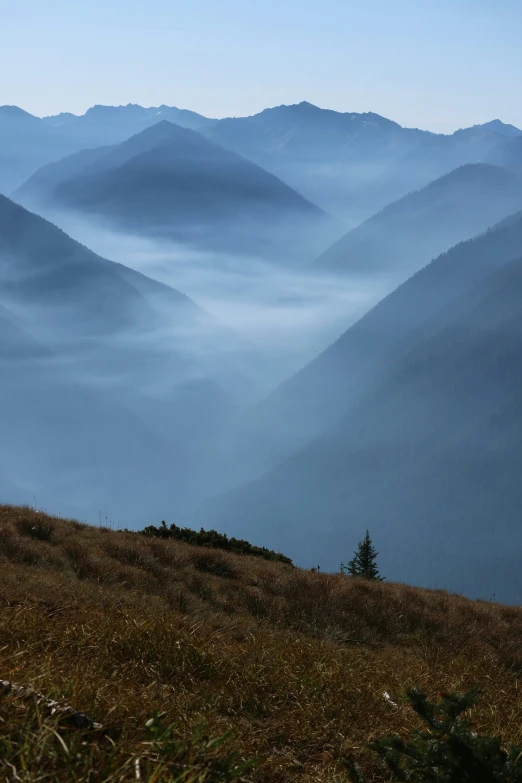 a lonely man is standing alone in the mountains