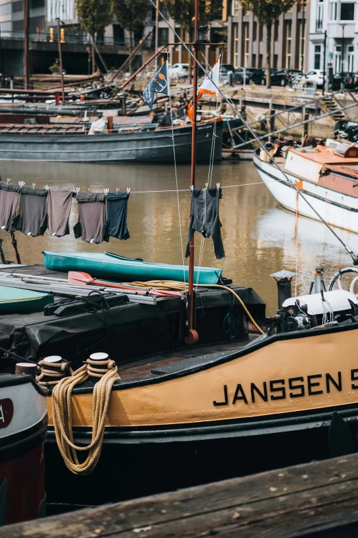 small tug boats in a river next to another boat