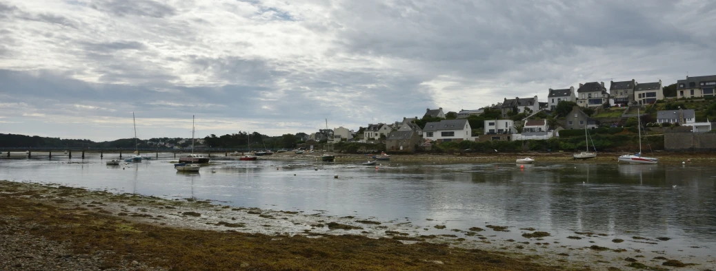 a body of water filled with boats next to buildings