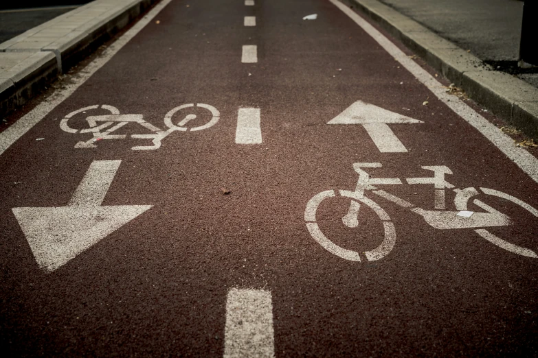 an empty road with some signs and bicycles