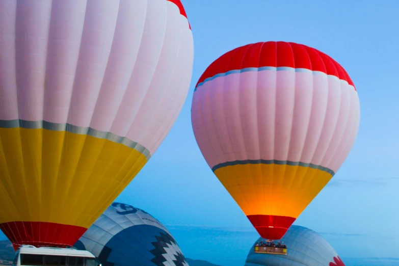 several  air balloons in different colors against a blue sky