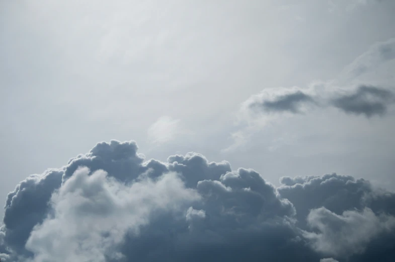 two airplanes flying through a cloudy sky during daytime