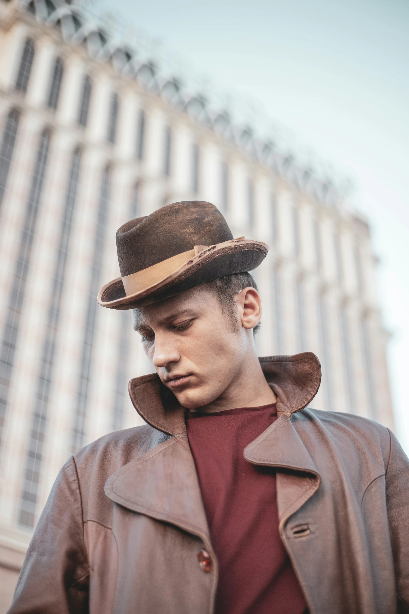 a man wearing a brown hat while standing