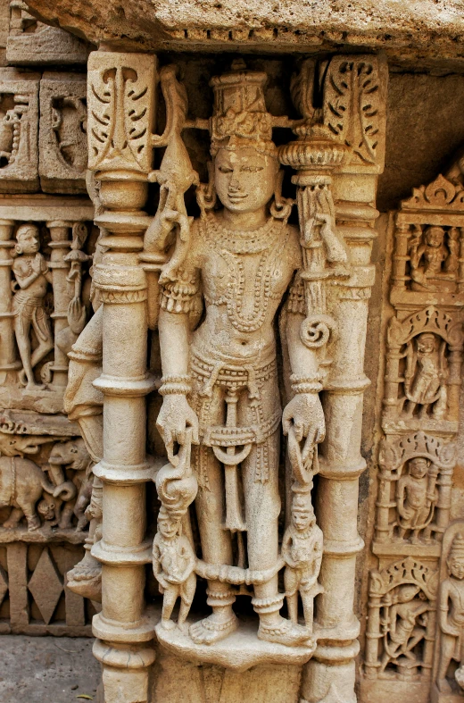 carvings at the top of pillars with hindu writing