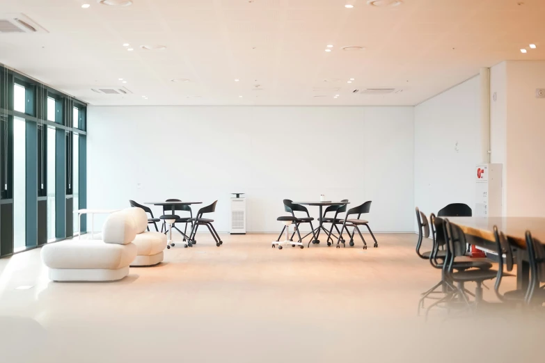 this is an empty meeting room with tables and chairs