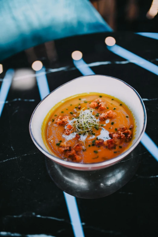 a bowl of soup sits on a table