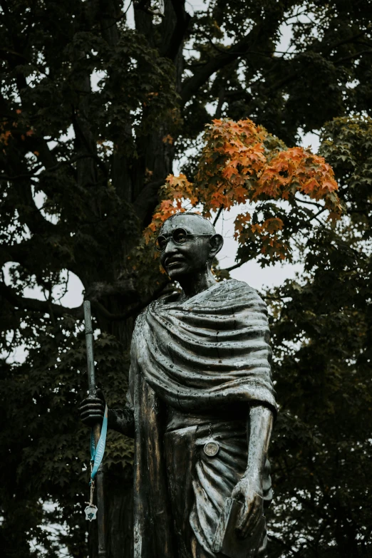 there is a statue that is standing near trees