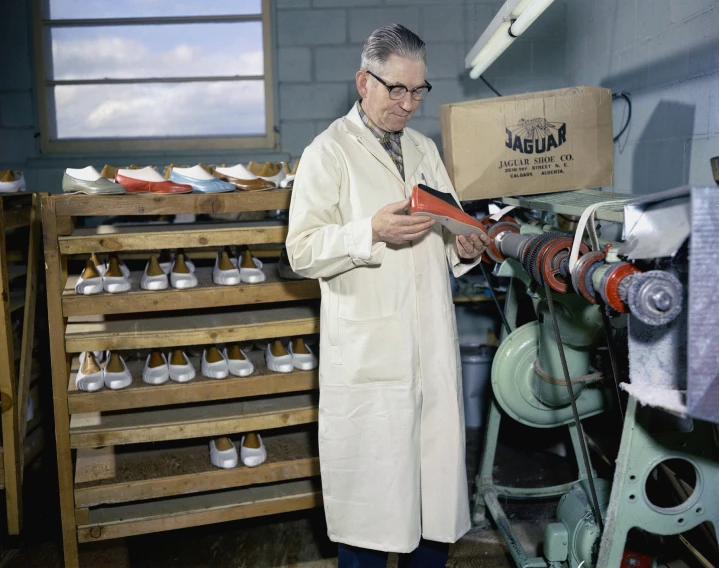 an older man standing next to a shelf