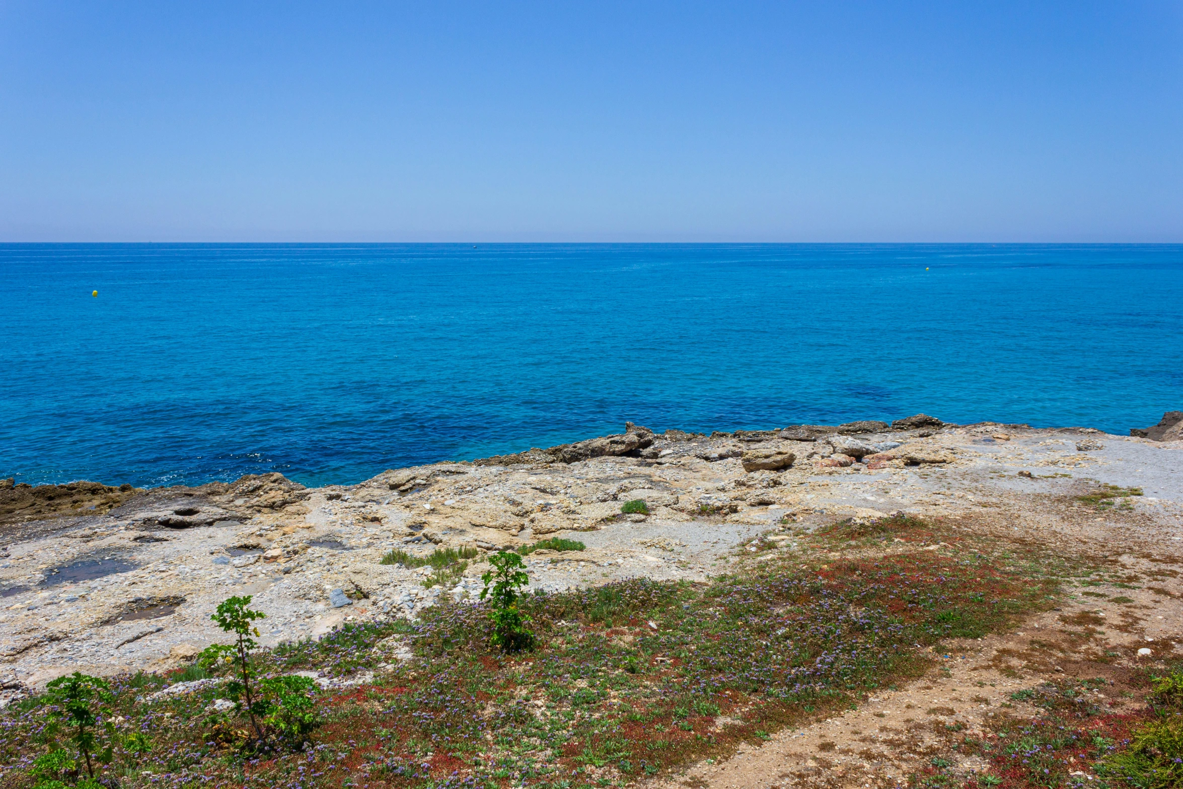 a body of water with blue water behind it