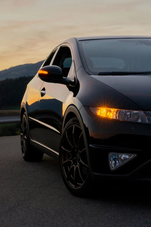 an image of a black car driving down the road