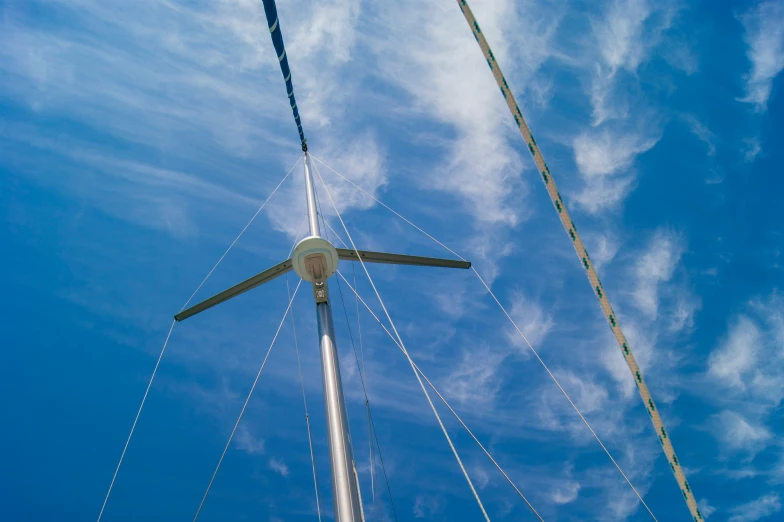 a white pole on top of the mast of a boat