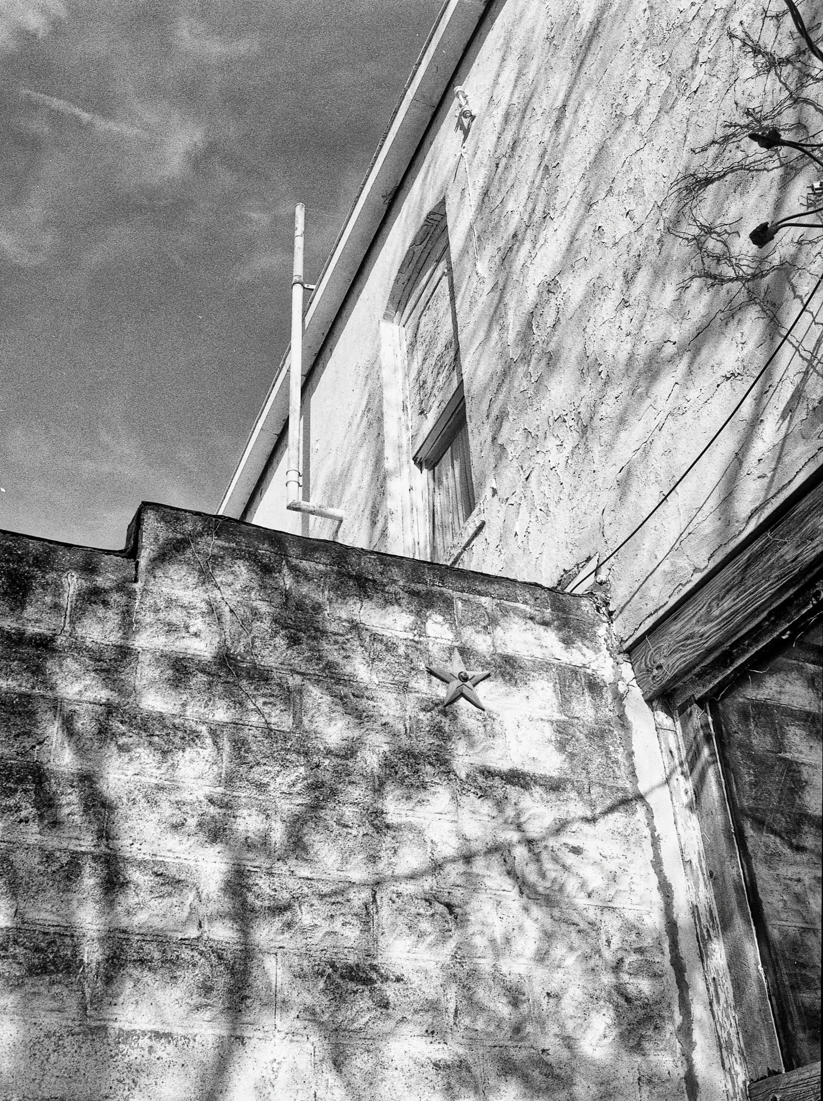 an old building with the doors closed and a clock on it