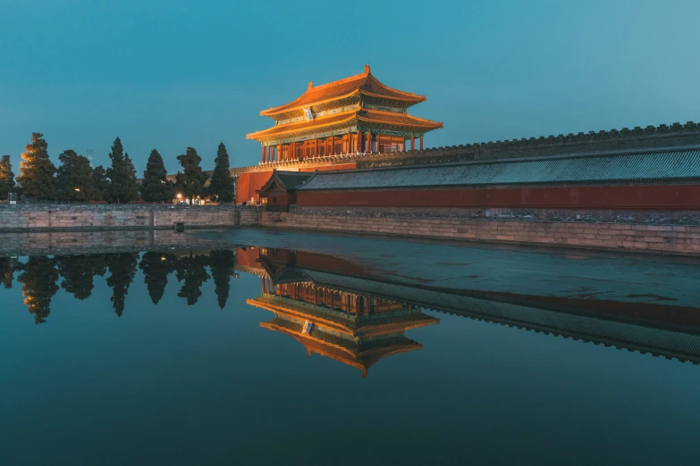 the wall is reflecting in water near a building