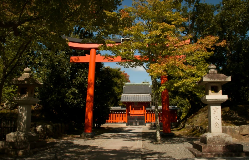 a gate leads to a shrine with a tori - wheel