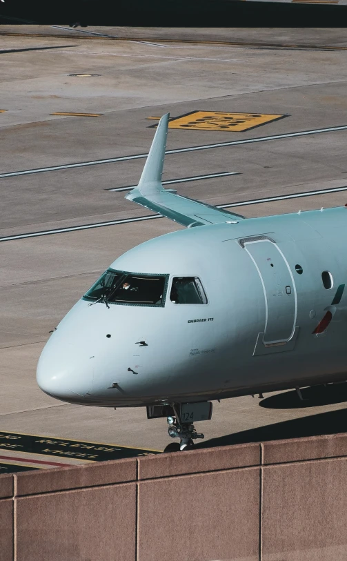 an airplane parked on a concrete runway at the airport