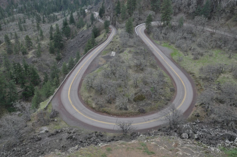 two curving roads in an open landscape with hills