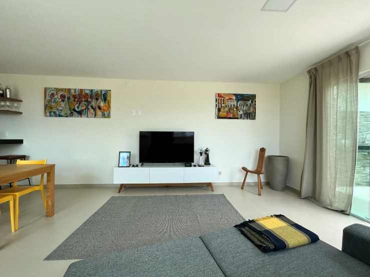 a room with a gray couch and black table