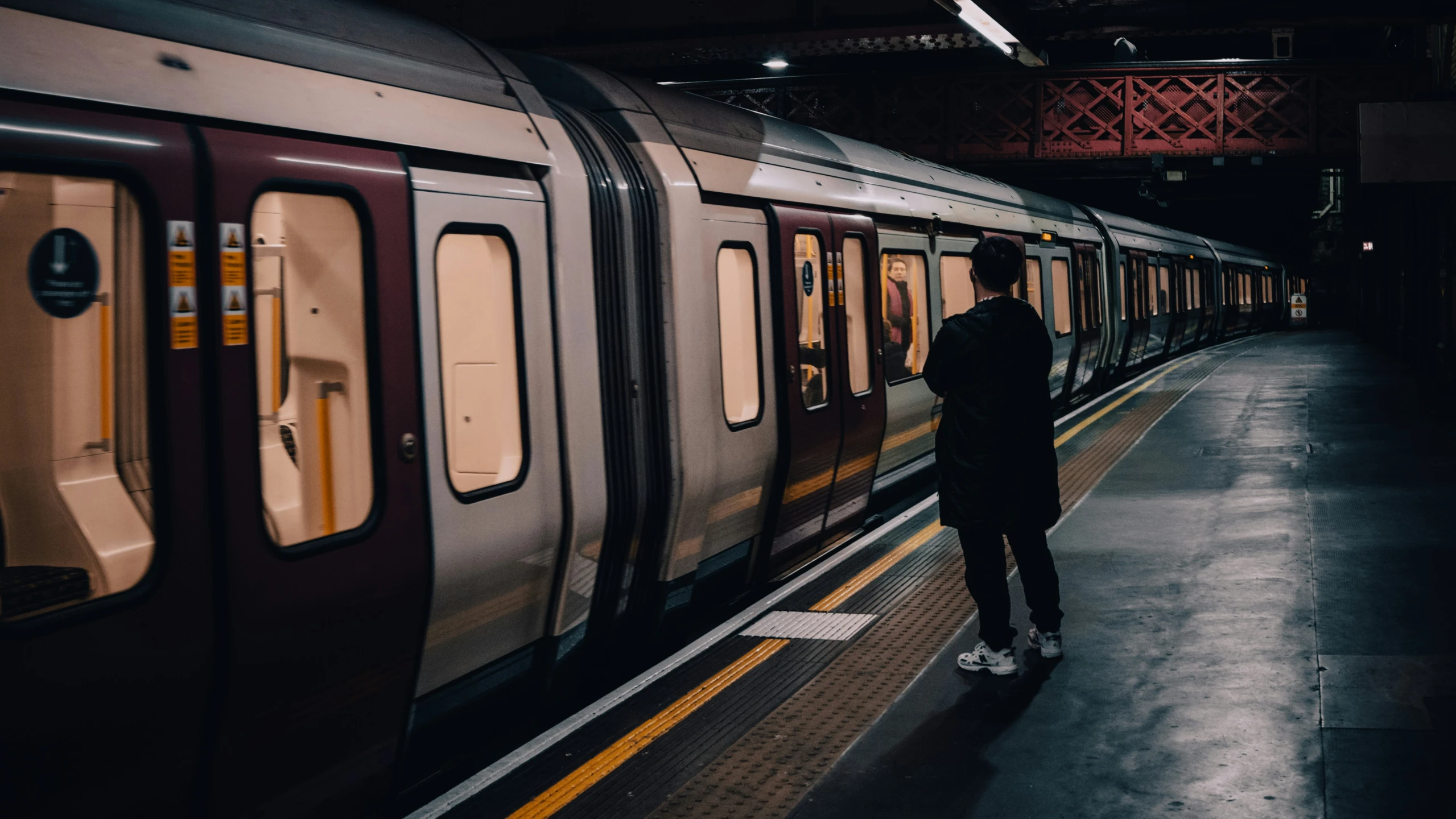 a person standing at the entrance of a train station