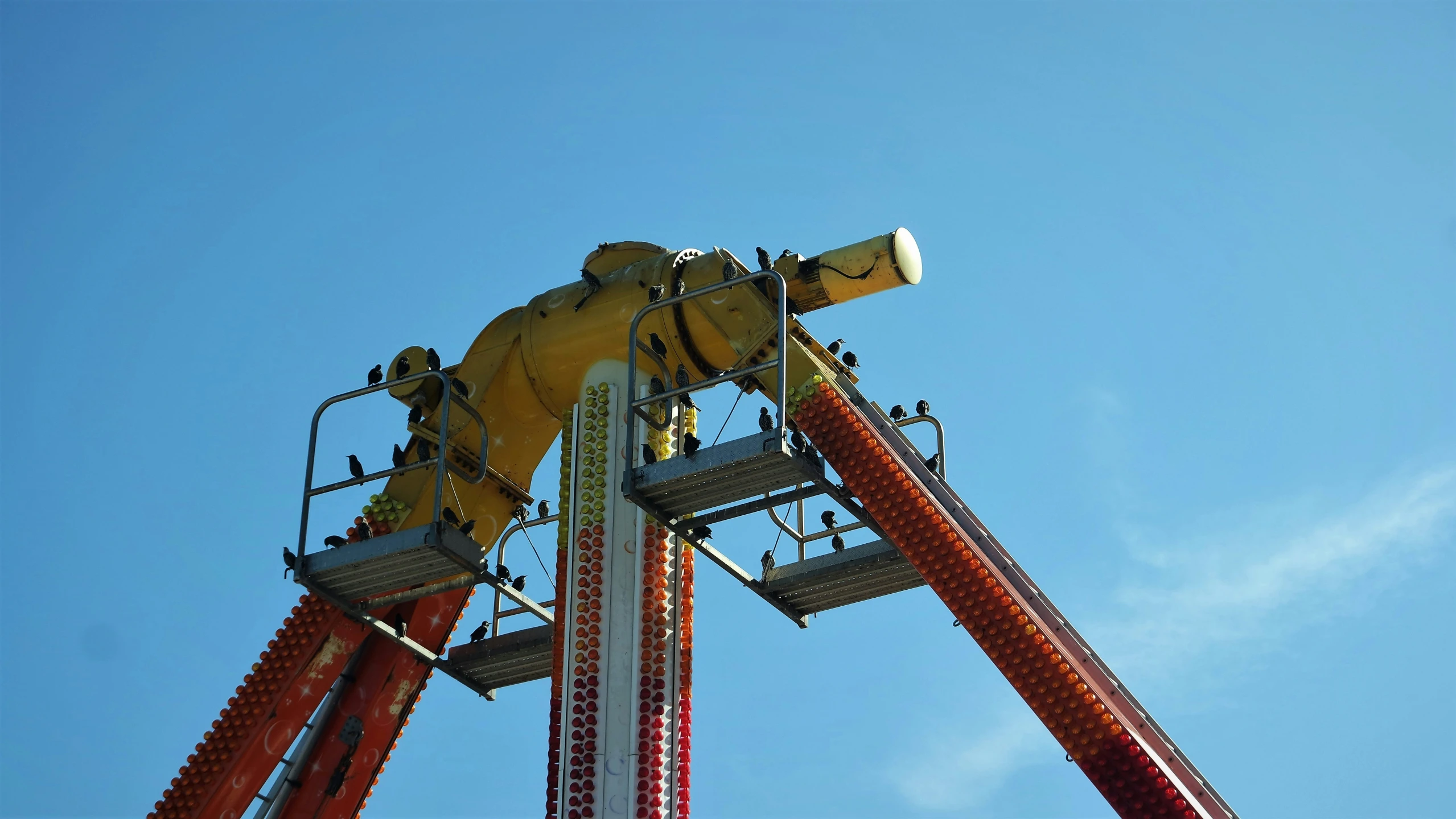 a ferris wheel with a blue sky and clouds in the background