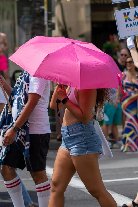 a couple of people walking down a street while holding umbrellas