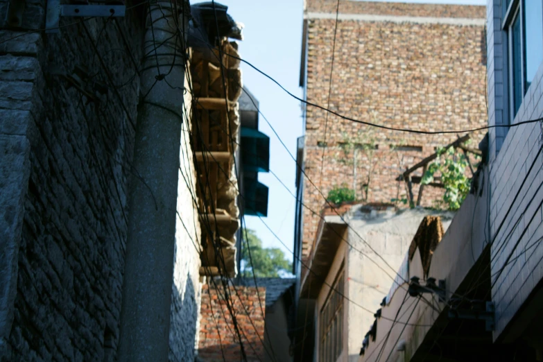 the back side of a building with a bricked wall and traffic light