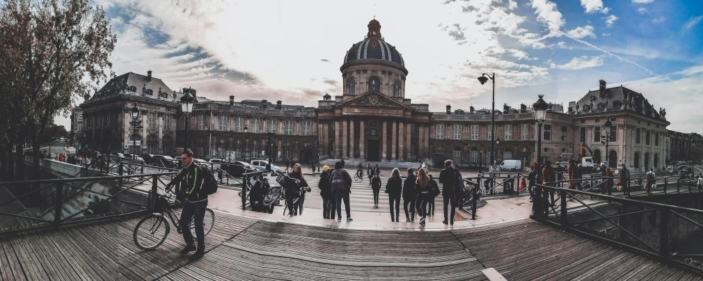 several people walk around an elaborately designed city square